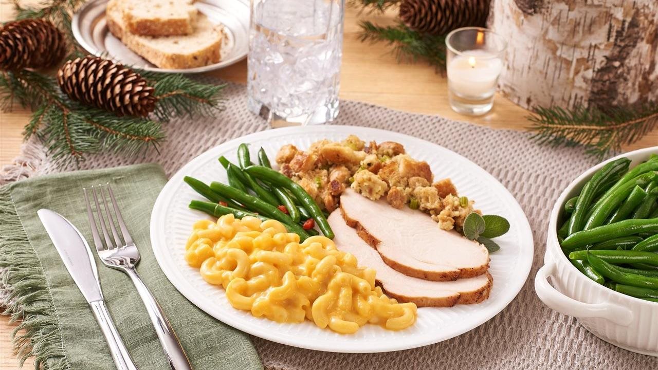 Turkey, dressing and green beans on a plate with Bob Evans Macaroni & Cheese.