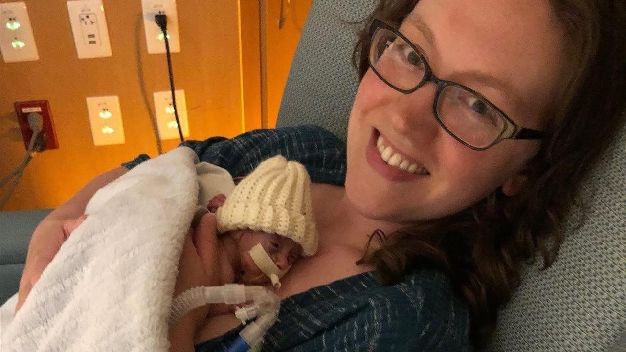 Noah and mom sitting in a chair at the hospital