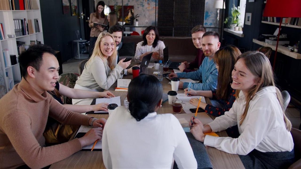 Group of friends sitting at a table in a coffee house.