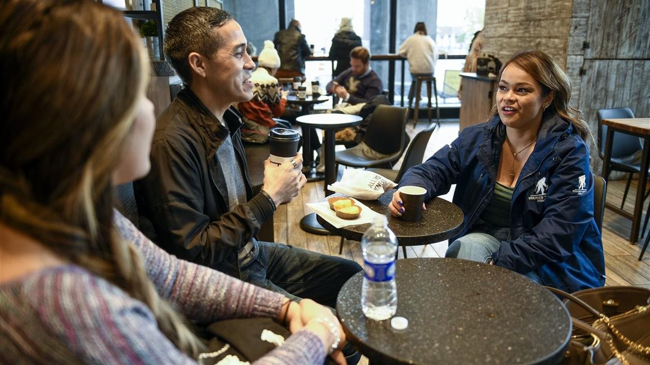 Antoinette in a cafe talking with other members of the wounded warrior project.
