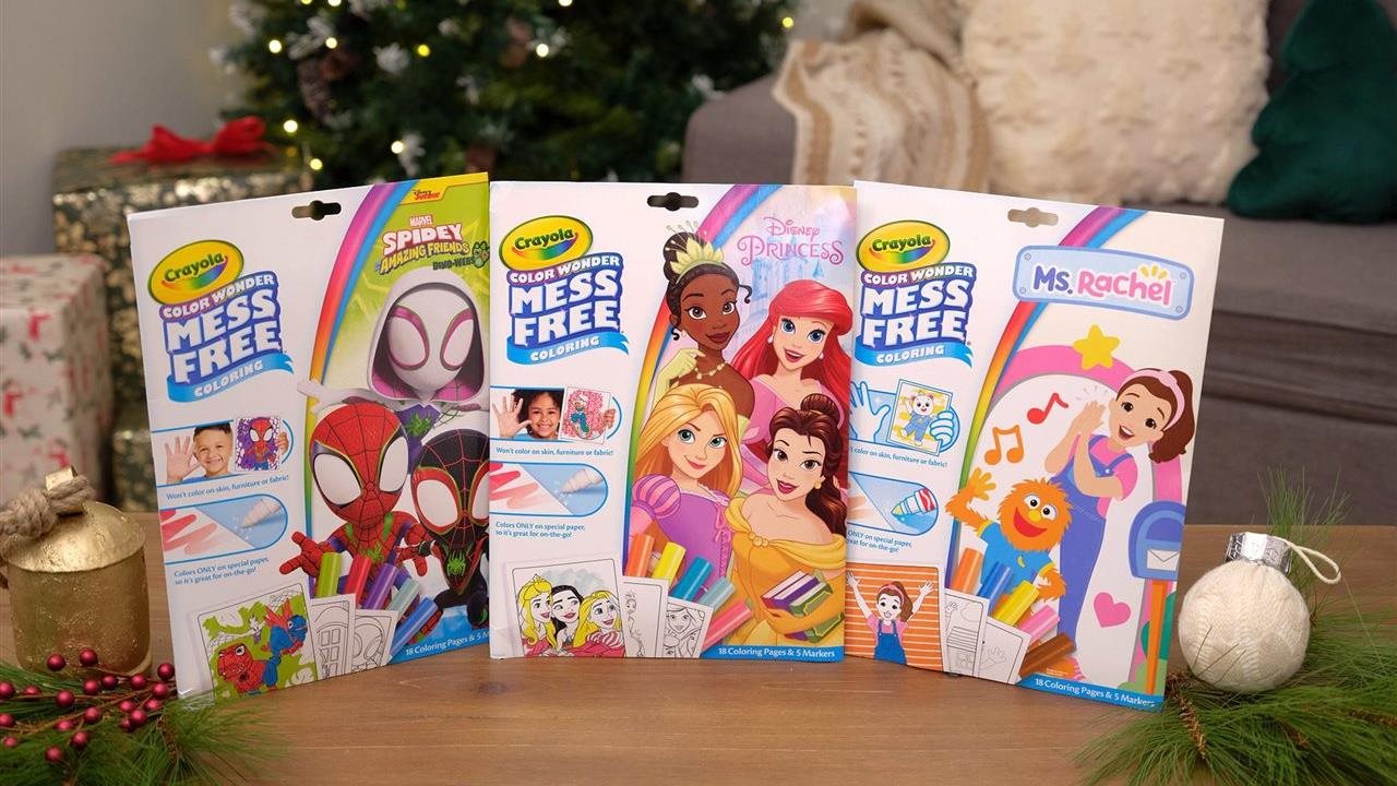 Crayola color wonder coloring pages in Spidy, Disney Princess, and Ms Rachel versions on a table in front of other gift under the tree.