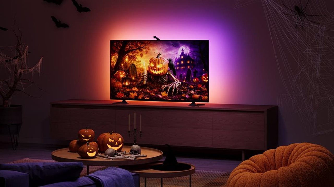 Govee backlight TV displaying spooky movie in Halloween decorated living room.