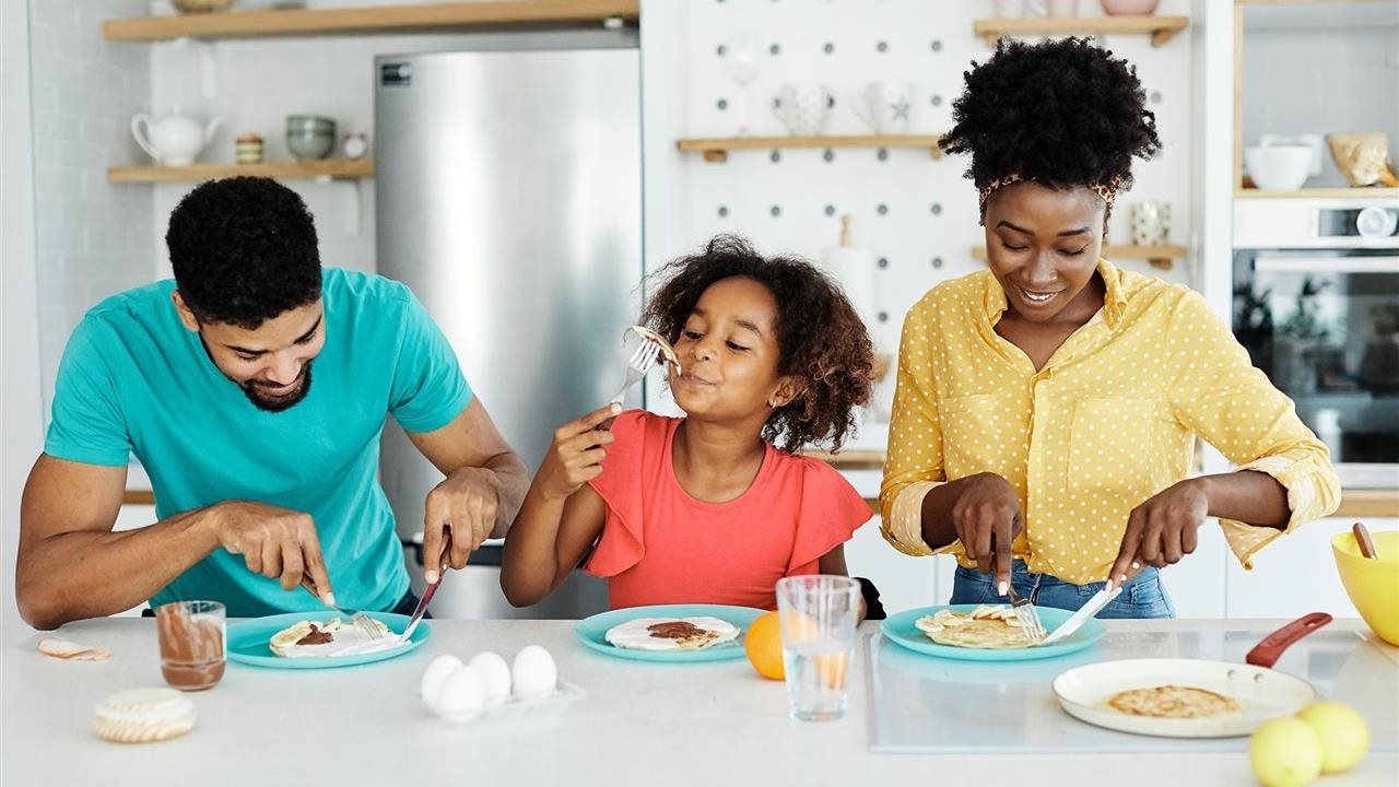 Family of three eating pancakes. Land O' Lakes is the fan favorite butter brand.