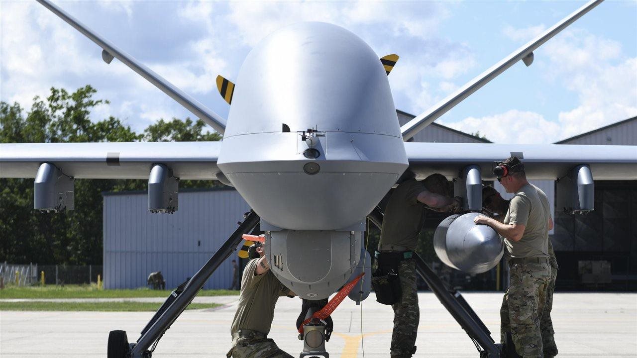 Men work on an aircraft. Michigan Economic Development Corporation (MEDC) examined today's defense and aerospace sector.