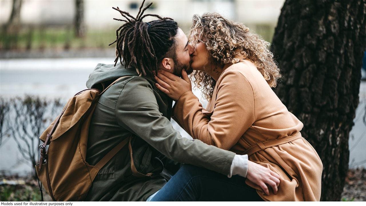 Couple kissing on a park bench in the Fall. The U.S. Food and Drug Administration (FDA) recently approved NUZOLVENCE® (zoliflodacin) for oral suspension), a single-dose oral antibiotic for the treatment of uncomplicated urogenital gonorrhea.