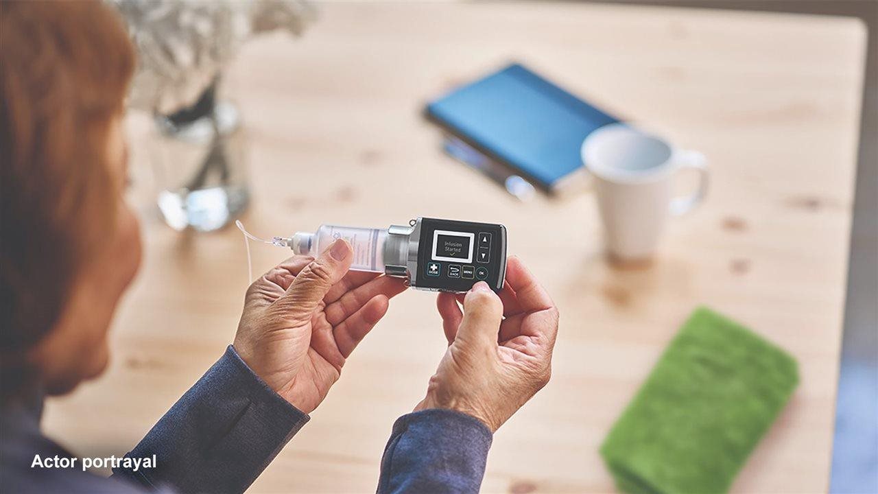 A woman looks at her ONAPGO device.