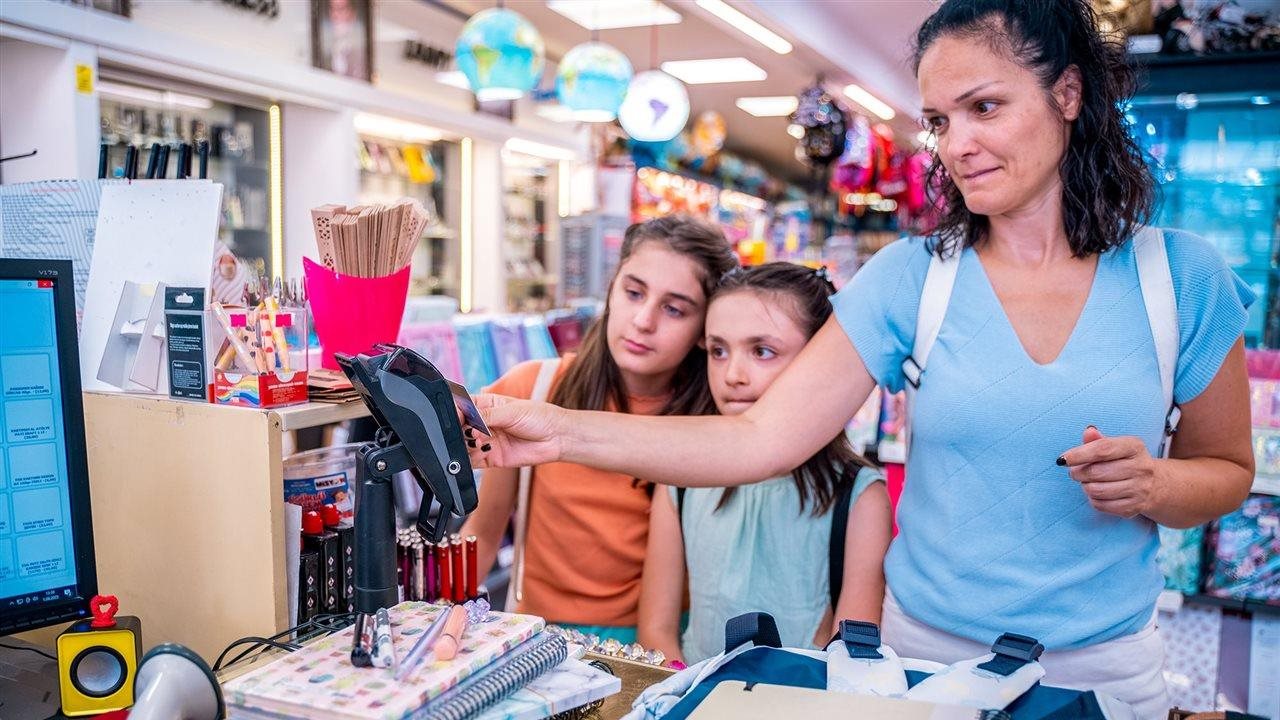 Mother back to school shopping with daughters.