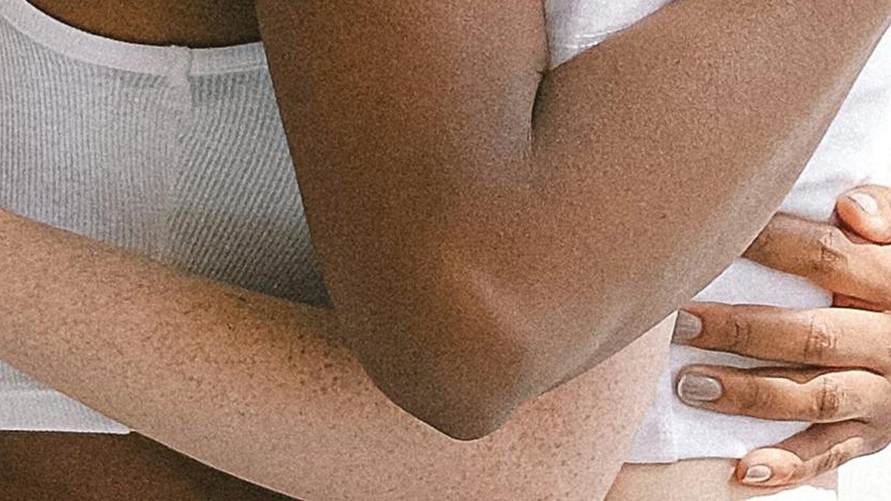 Multicultural friends embrace in their cozy cotton shirts.