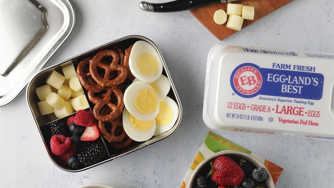 Fitness snack pack, in a travel tin, that includes: pretzles, cheese, fruit and Eggland's Best eggs because they contain more than double the Vitamin B12 and Omega-3s compared to ordinary eggs.