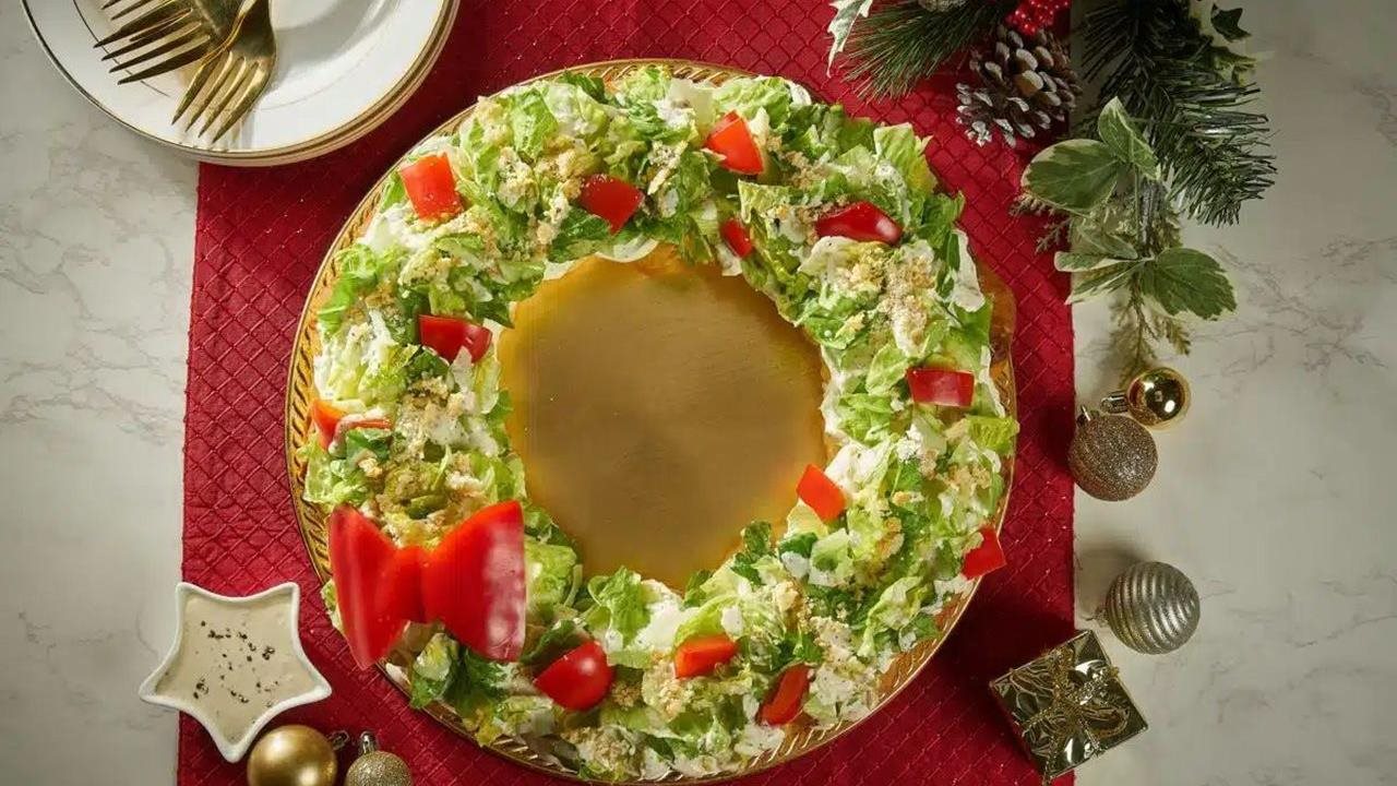 Pull-apart Caesar salad wreath on a beautifully decorated holiday table.