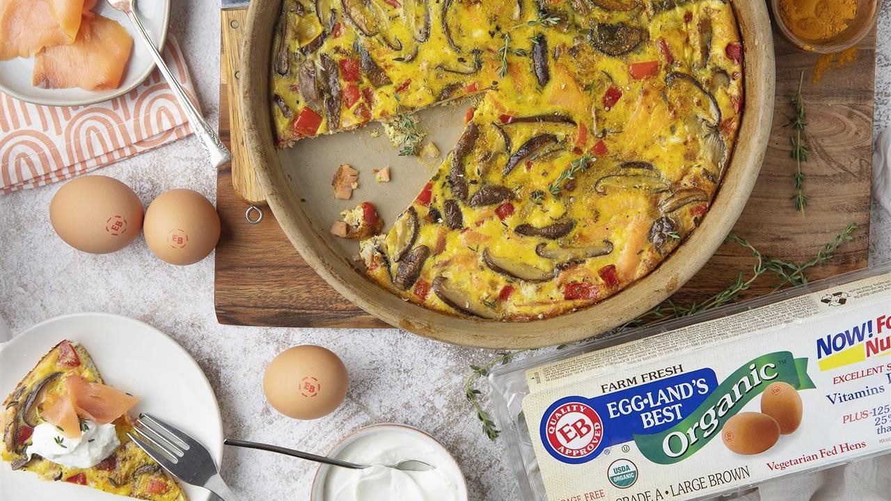 Shiitake Mushroom & Red Bell Pepper Frittata with Smoked Salmon in a pan next to a carton of Eggland's Best.