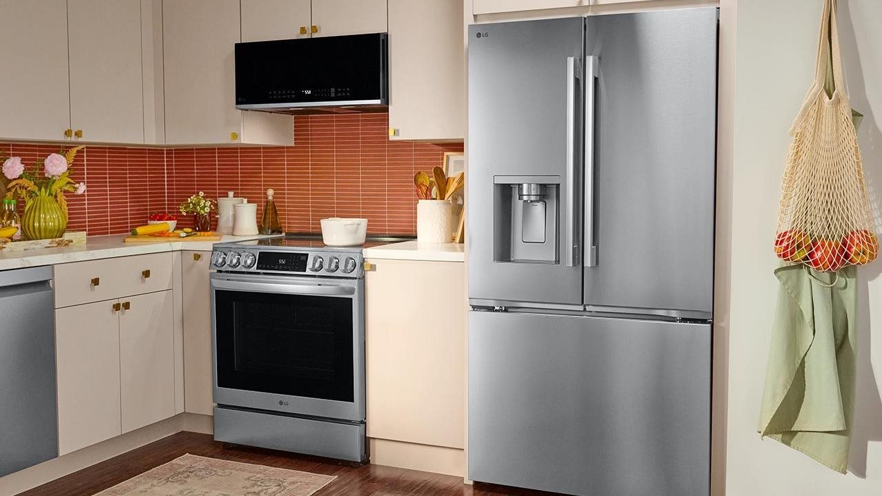 LG Counter-Depth MAX™ with Zero Clearance™ 3-Door French Door Refrigerator in retro mid-century kitchen with cream cabinets and red mini-subway tile.