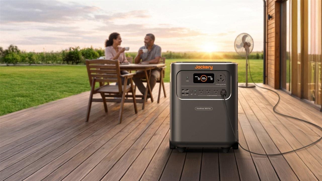A couple outside on the deck enjoying the cool breeze of a fan powered by a Jackery back-up power generator.
