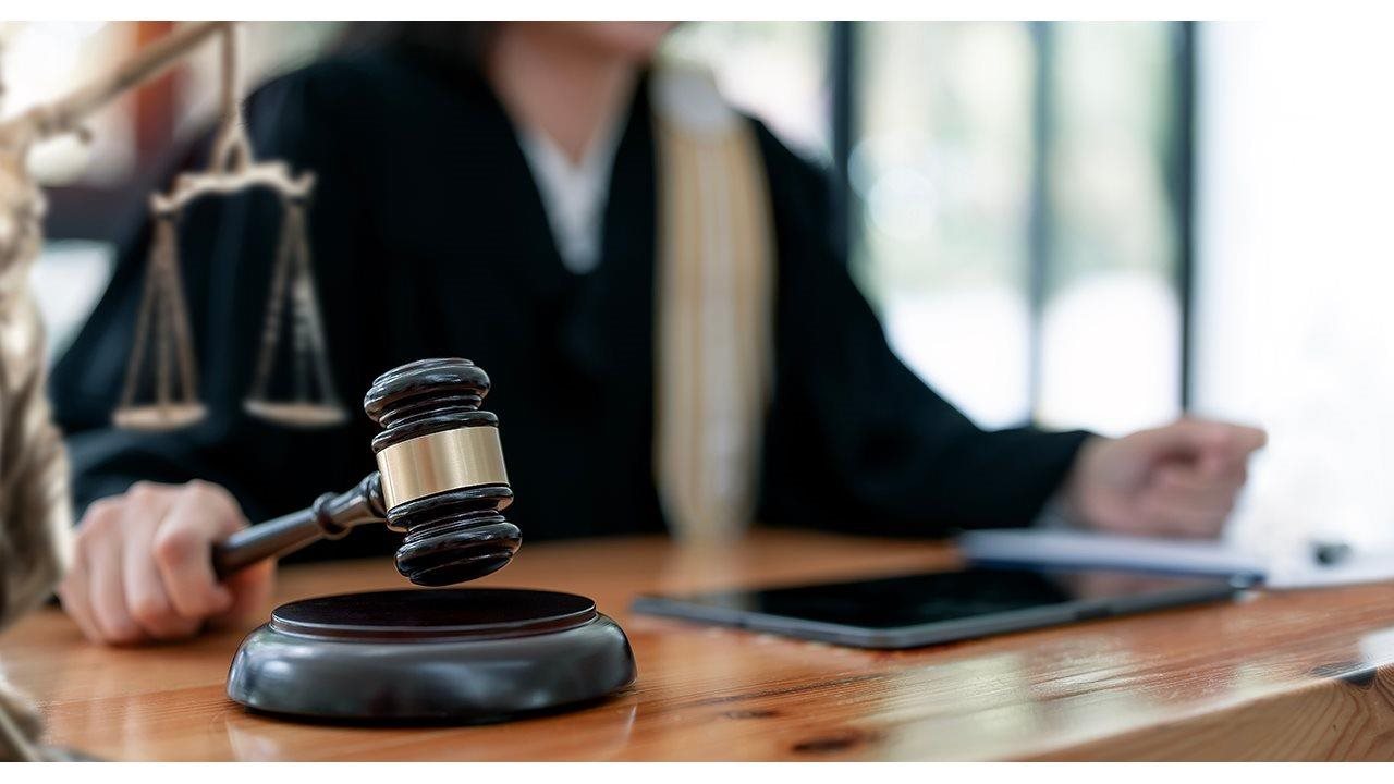 Judge pounding gavel in a courtroom.