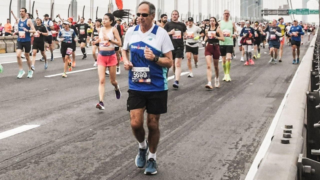 Media executive John McConnell participates in a run with Team Reeve across a suspended bridge.