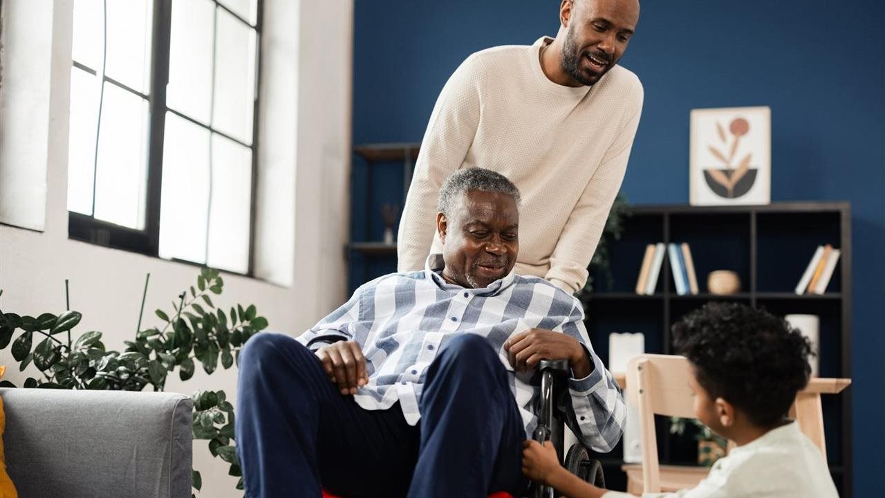 Male caregiver with his dad and son at home. NextGen Healthcare uses Clinical AI and intelligent automation.