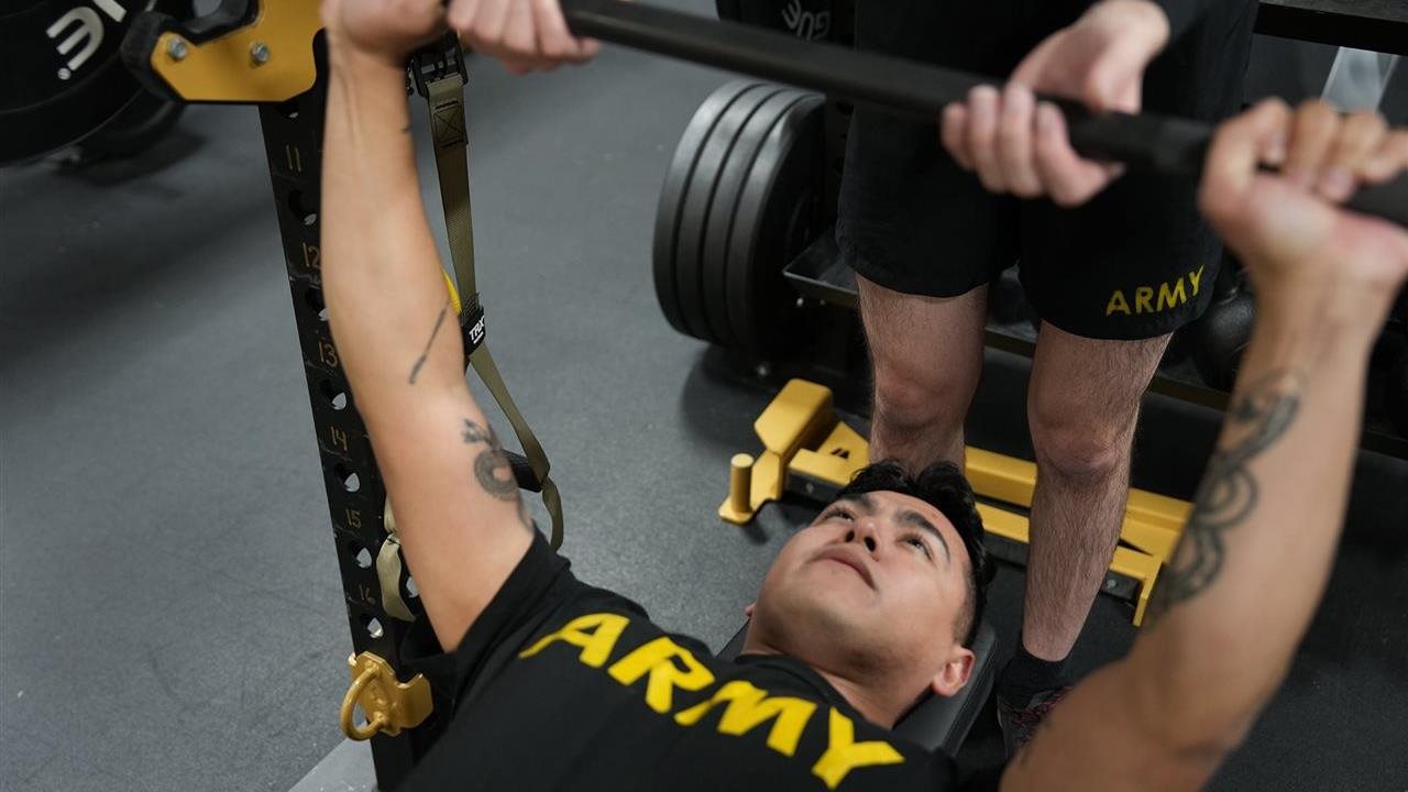 U.S. Army Soldier lifting weights in the gym as part of the Holistic Health and Fitness (H2F) system.