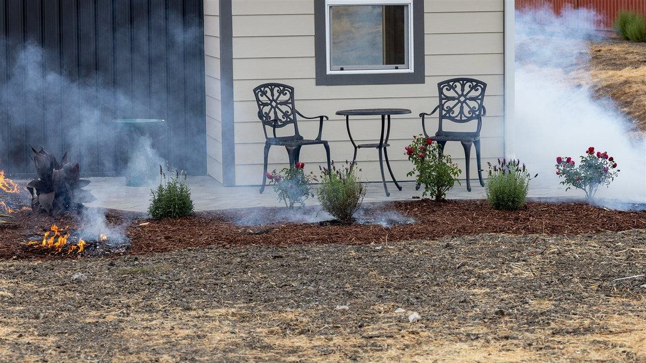 Small smoky fire burning outside a home.WildfirePrepared.org can help you prepare your home in case of wildfire.
