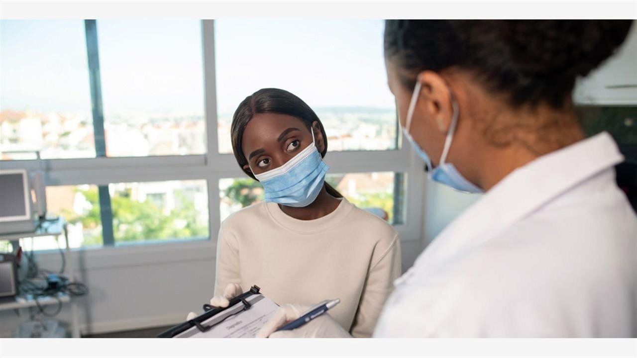 Doctor and patient in masks. After April 16, a policy could restrict heakth coverage for infectious disease to some Alabamians.