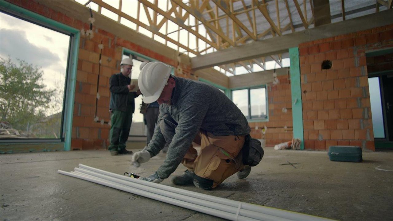 Worker measures PVC pipe in garage of new home. The Vinyl Institute says PVC pipe is widely used for drinking water service.