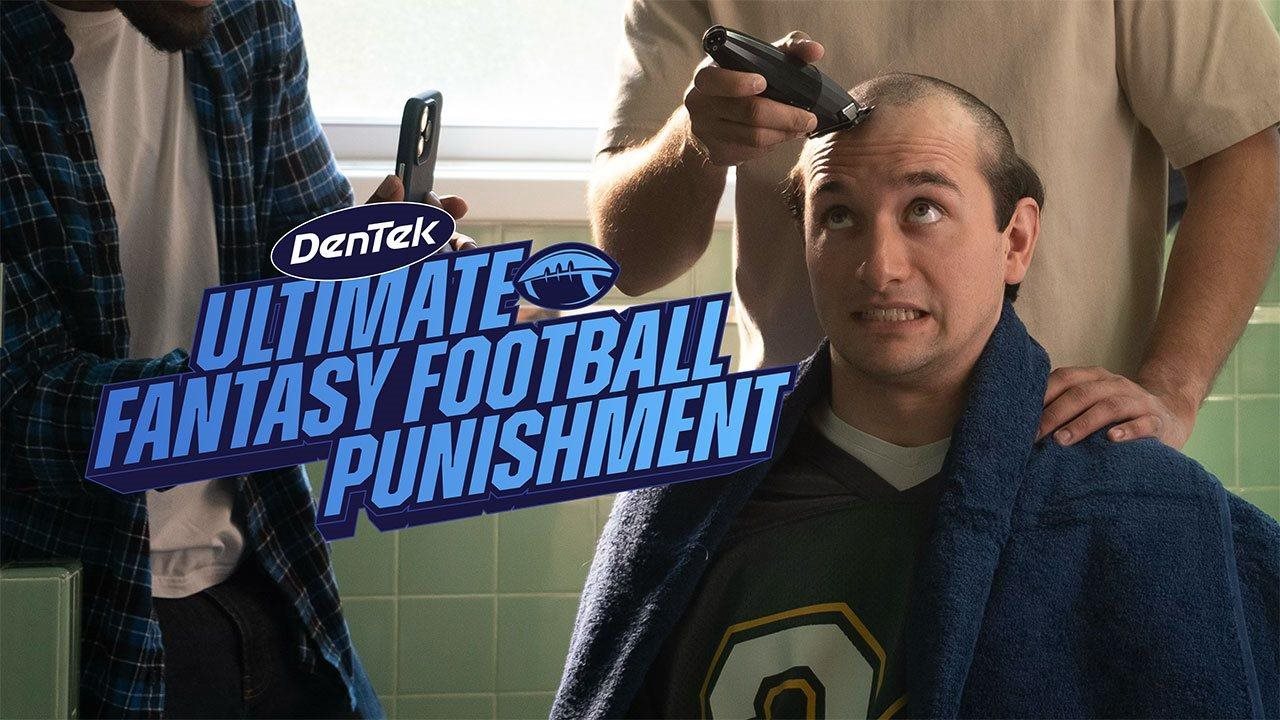 Man getting his head shaved by his fantasy football friends as a punishment for loosing.