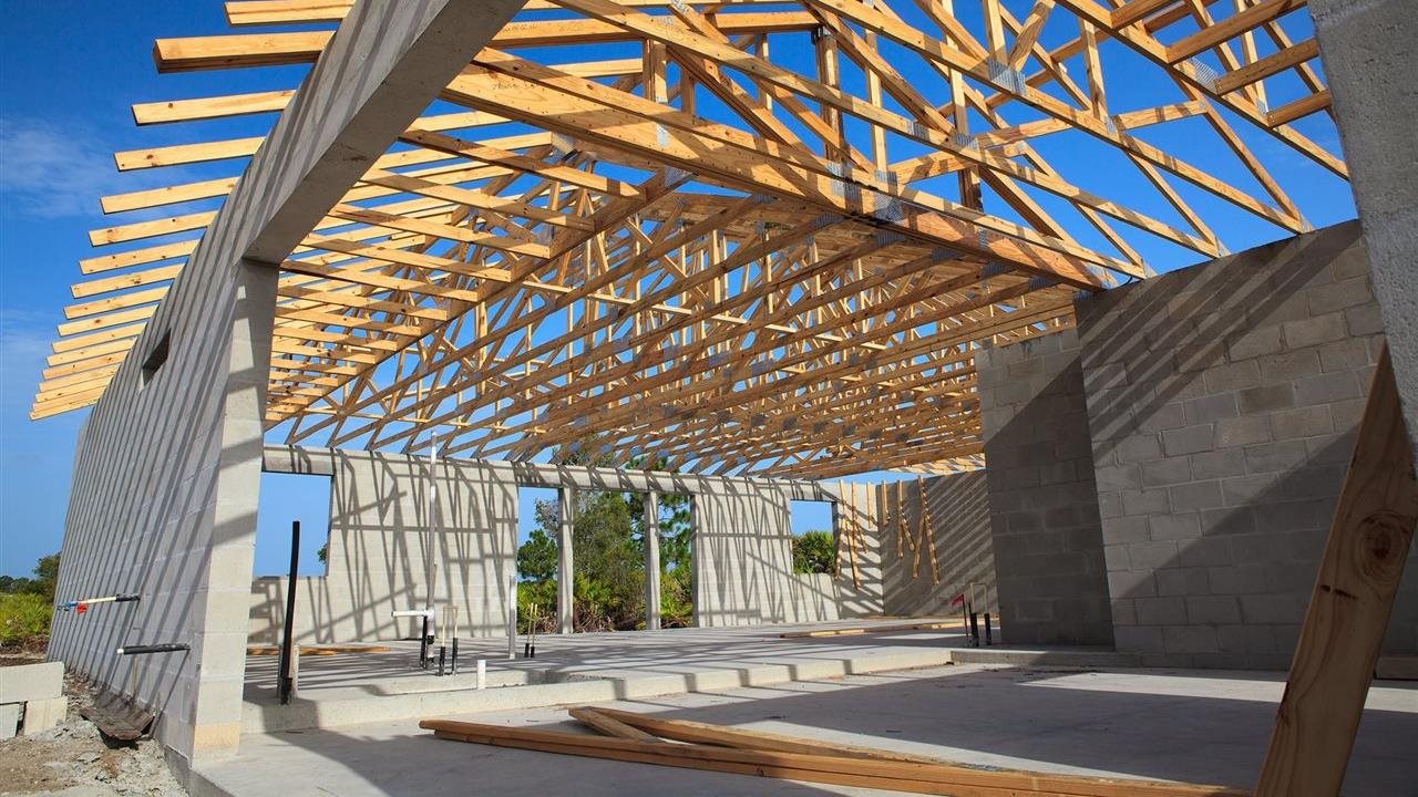 Concrete block structure with wooden trusses in place for roof