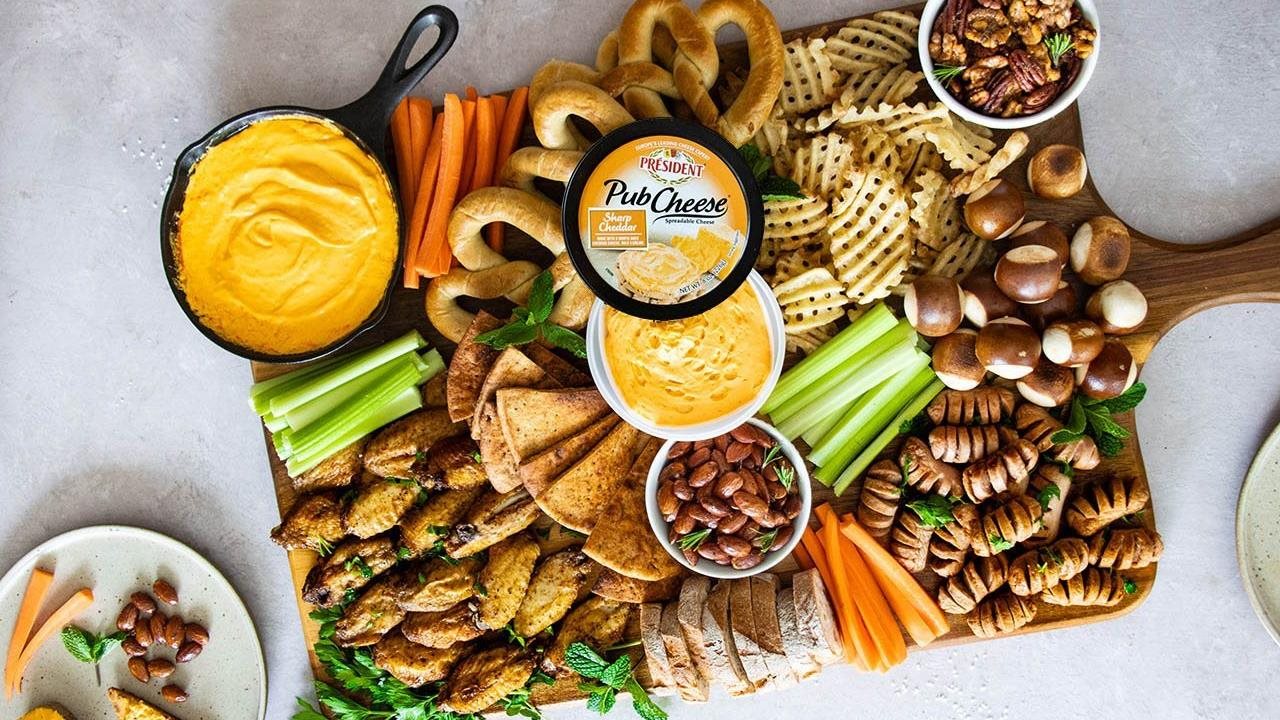 Président® Pub Cheese® Stadium Snack Board including pub cheese, carrots, celery, pretzles nuts and chicken wings.