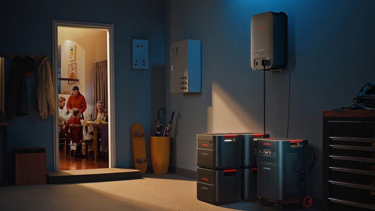 A family has dinner in kitchen and back up power in garage. The Jackery HomePower 3600 Plus battery is rated for 16 years.