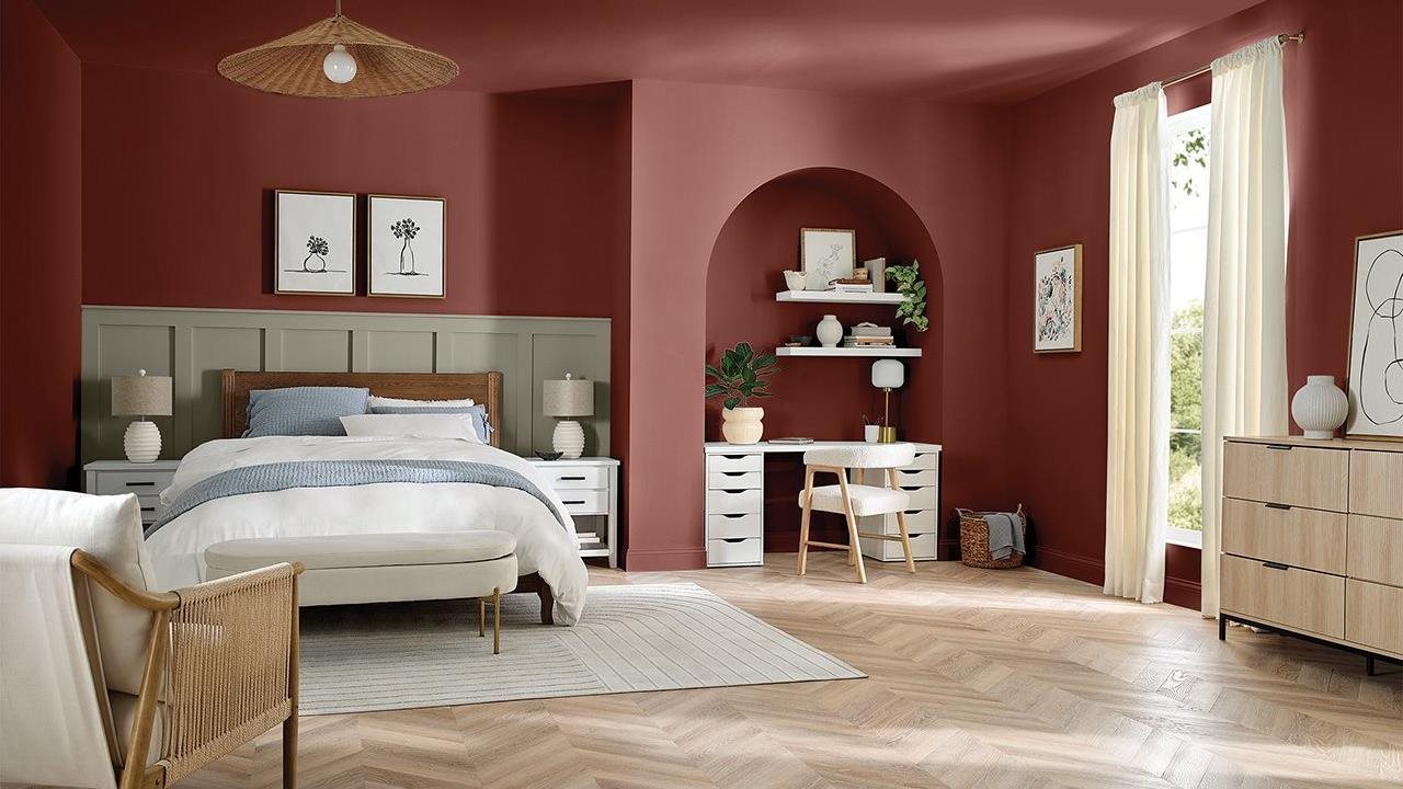 Beautiful upscale bedroom with dusty rose colored walls, light modern bedroom furniture and hardwood floors