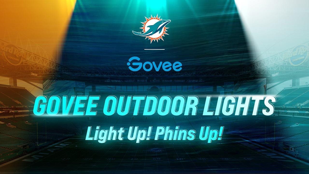 A stadium a wash with blue and orange lighting and a type that reads "Govee Outdoor Lights" "Light Up! Phins Up!"