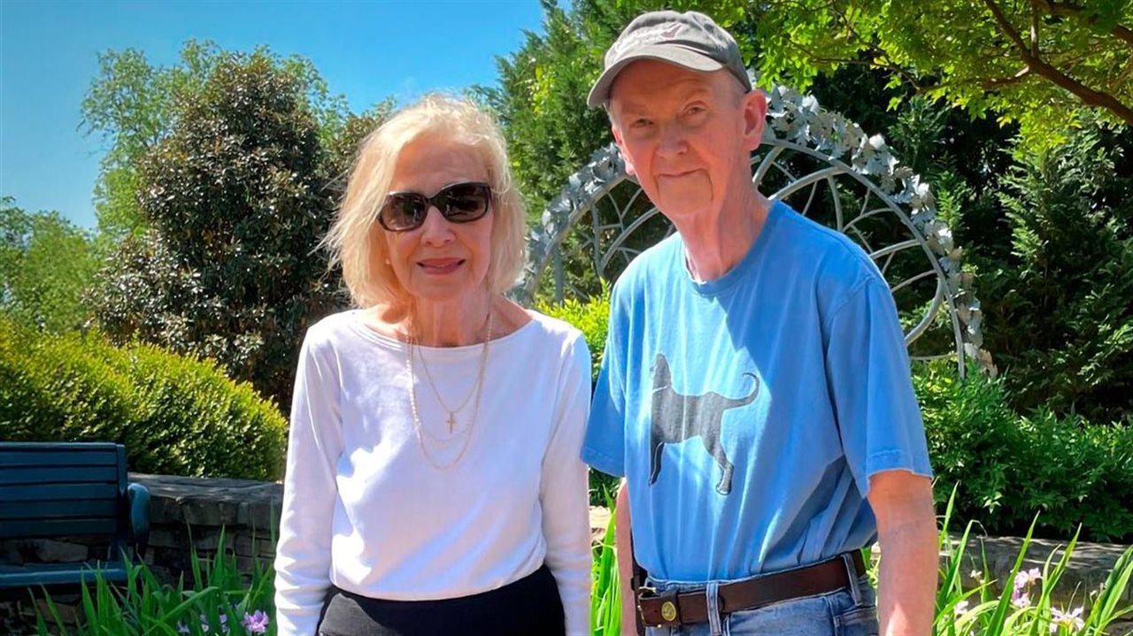 Smiling Lavonda and her husband in a park on a summer day.