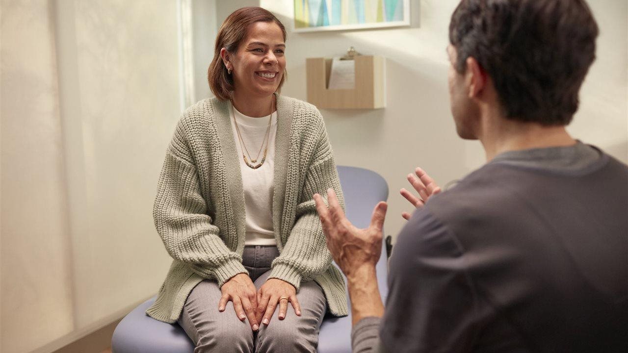 Woman talking with doctor in her office.