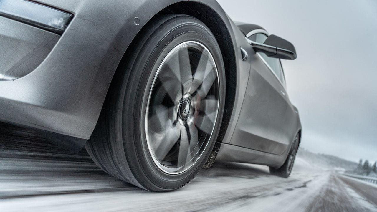 Sporty silver car driving on an icy road