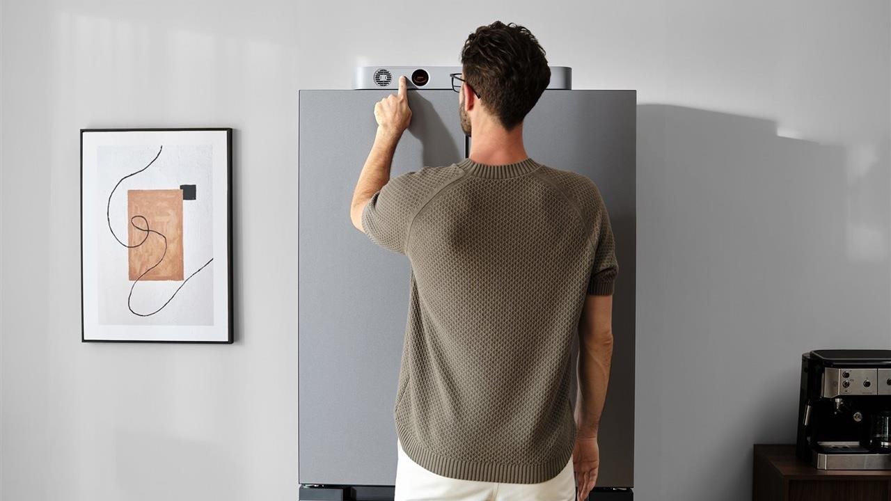 Man operates Jackery Fridge Guard on top of his refrigerator