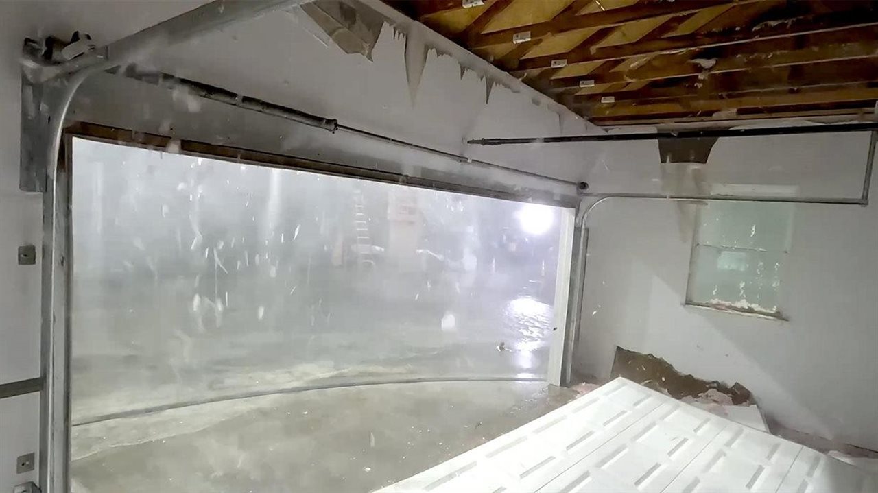 Hurricane breaking through a garage door. Insurance Institute for Business & Home Safety (IBHS) has a Hurricane Ready Guide.