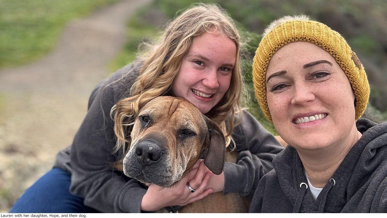 Lauren living with breast cancer, her daughter, and their dog.