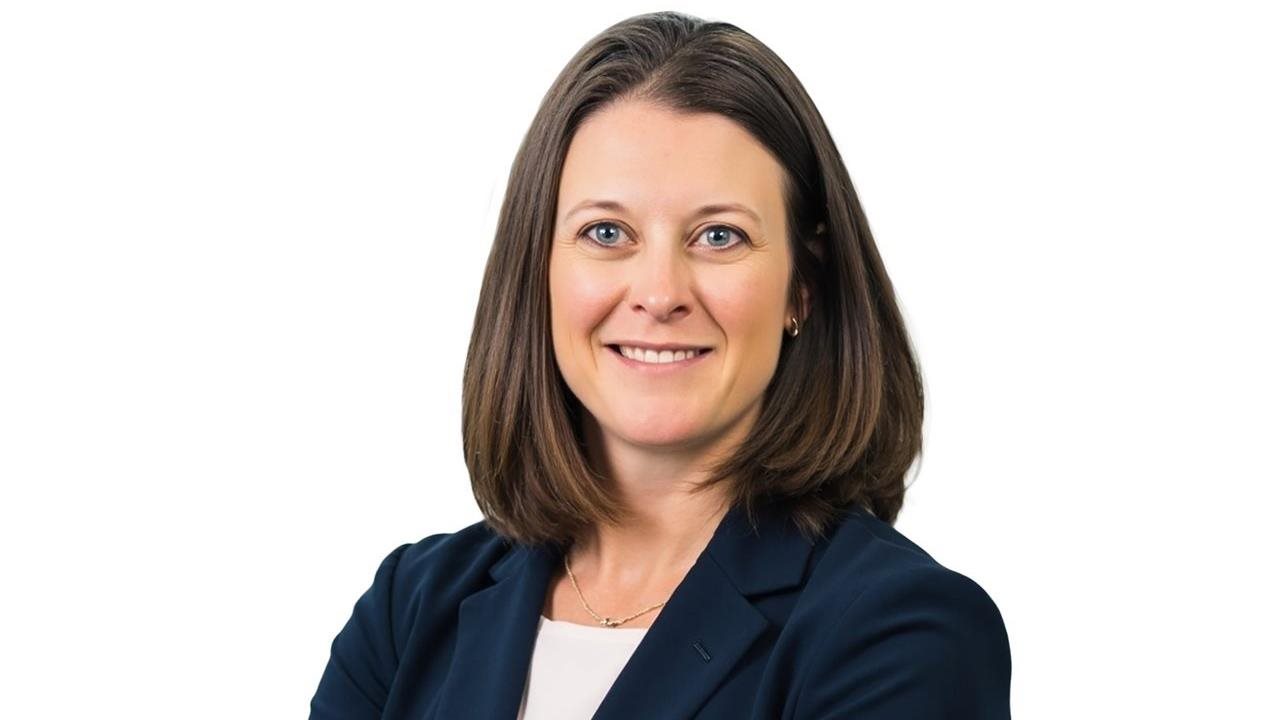 Adrienne Johnston, President and CEO of CareerSource Florida in a blue suit.