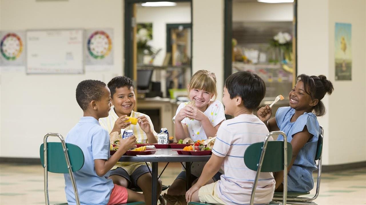 Children eating lunch in a school cafeteria. Students in Florida can get a balanced meal through the National School Lunch Program.
