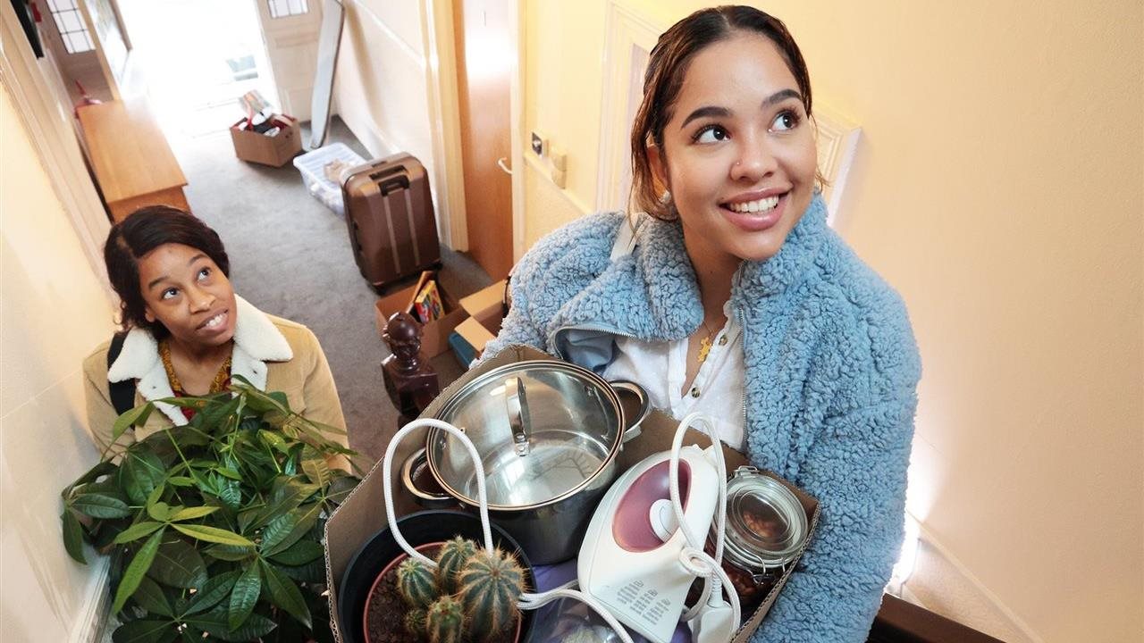 Young women moving into a dorm for college.