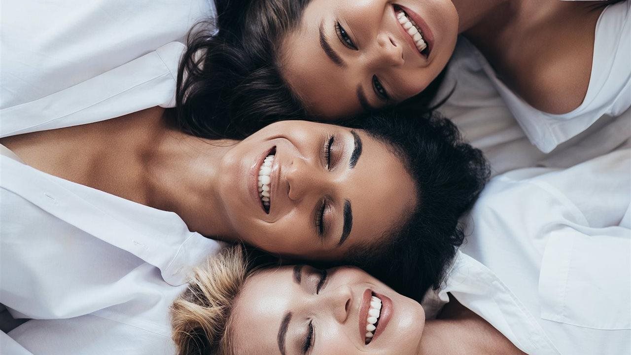 Three smiling woman in spa robes after a skin stimulation therapy with a machine like an LPG® endermologie®