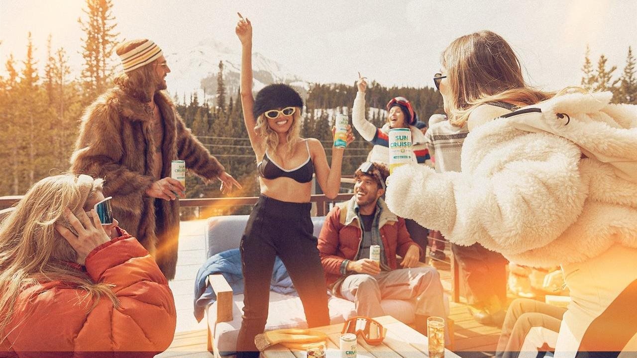 Friends enjoying Sun Cruiser beverages on a deck during Winter.