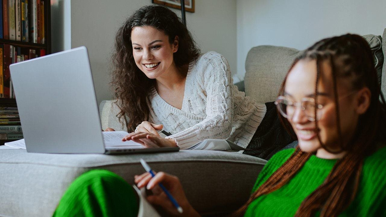 Young women working on computers in a dorm room. To learn about the benefits of 100% fiber internet, visit ZiplyFiber.com.