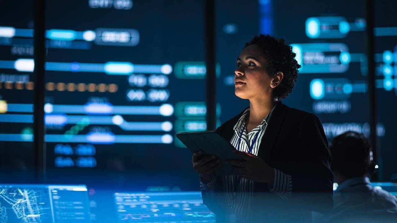 Woman working on computer at night
