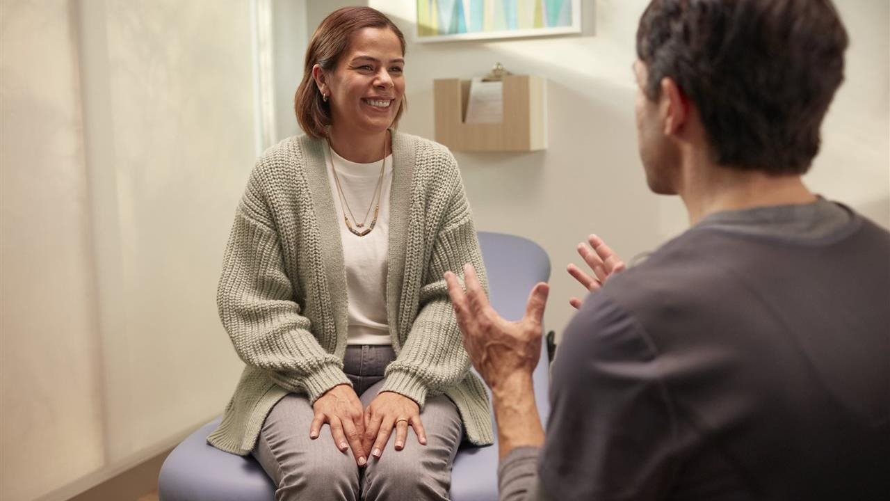Woman talking with doctor in her office.