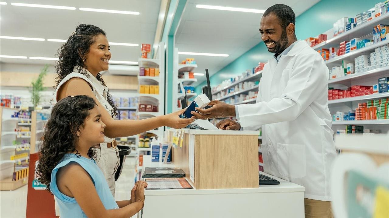 Mom and child at pharmacy plan for flu season. Walgreens has vaccinations, OTC meds and school supplies.