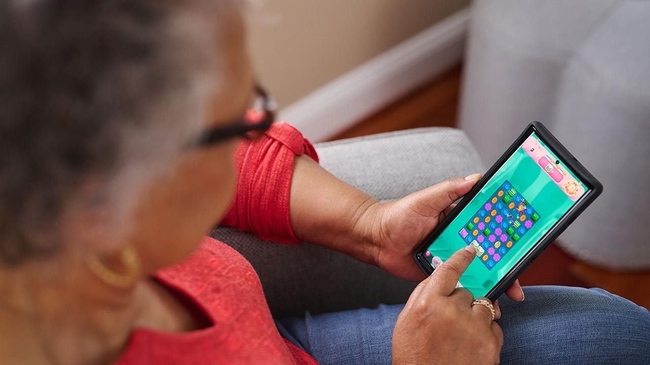 Senior woman playing a video game on her phone.