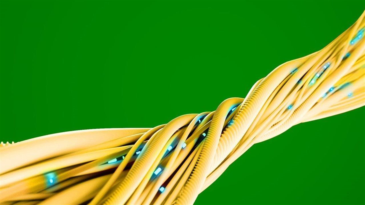 Yellow fiber internet cables against a green backdrop.