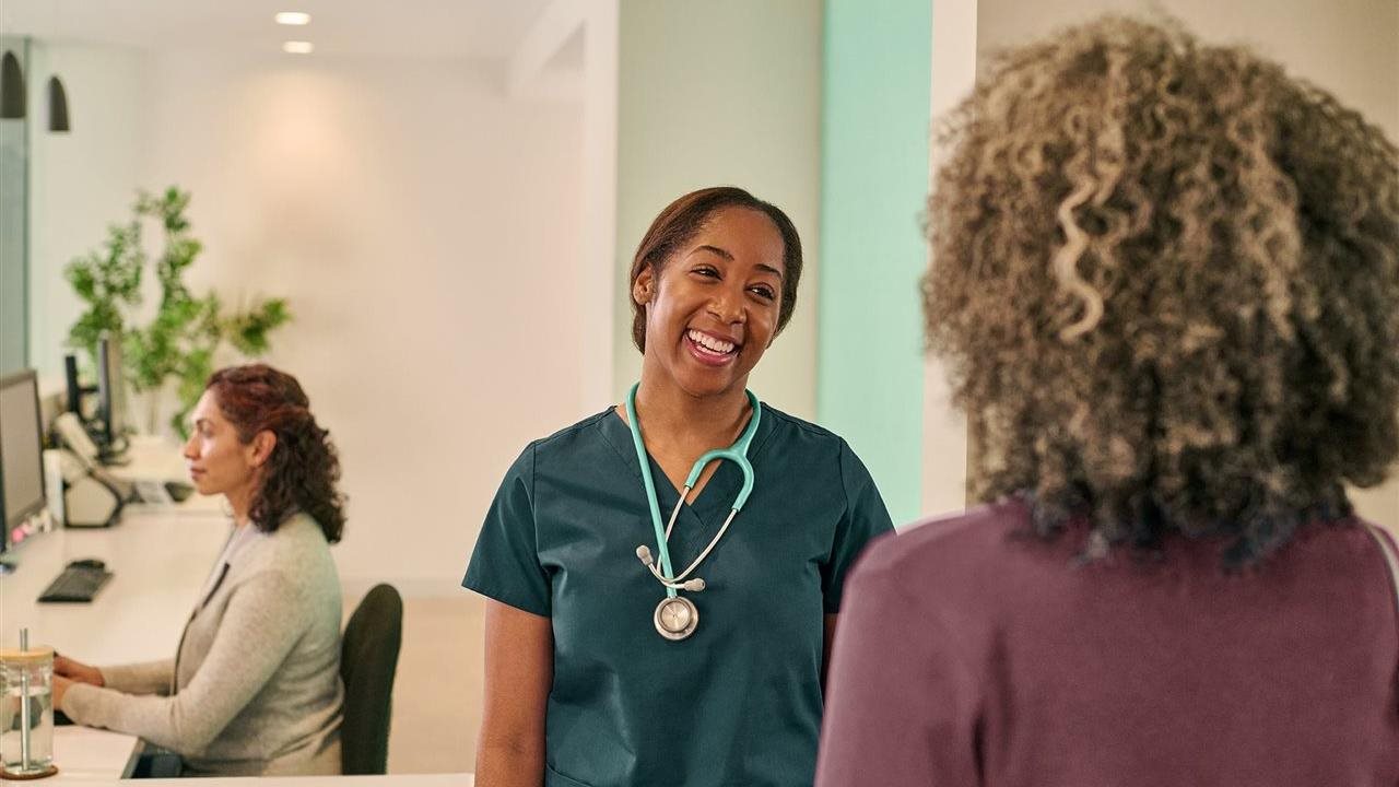 Patient in doctor's lobby. One Medical offers 30-minute appointments, same- or next-day availability, and 24/7 messaging.