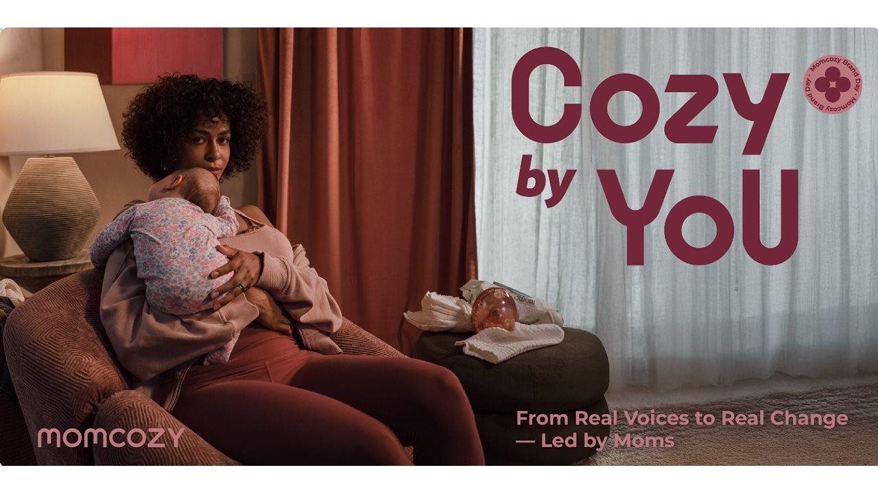 Mom holding her little baby while sitting in a cozy chair in the living room. There is type over the image that says "Cozy by you"