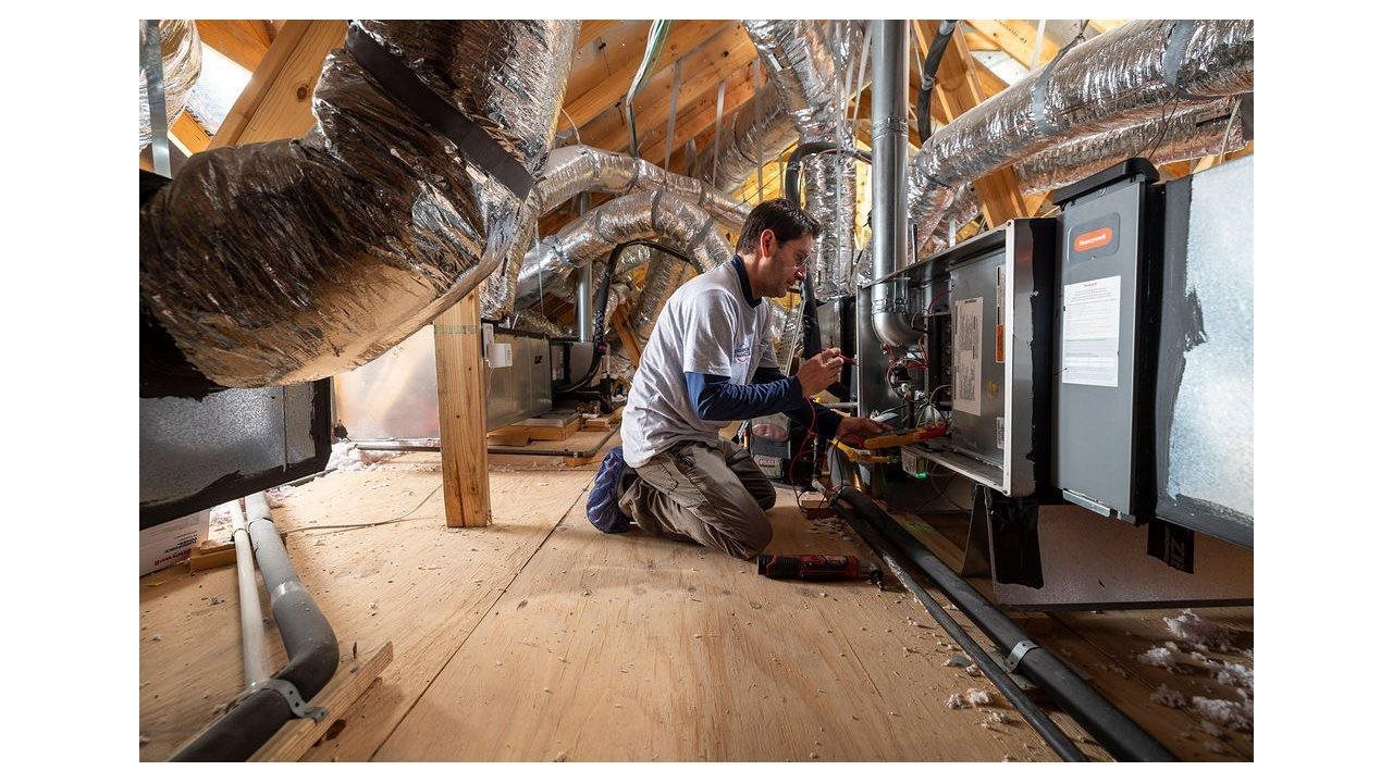 Representative working on a heating cooling system in a home.